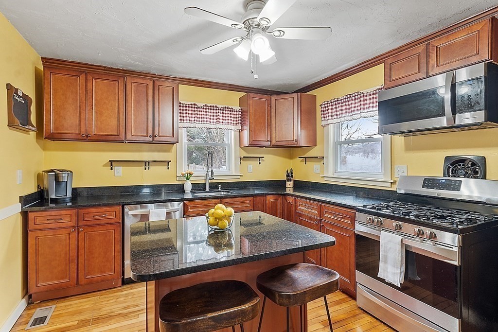 2 Cuba Road Worcester, MA 01603 - Photo 5 of 41 a kitchen with stainless steel appliances granite countertop a sink a stove cabinets counter space and a window