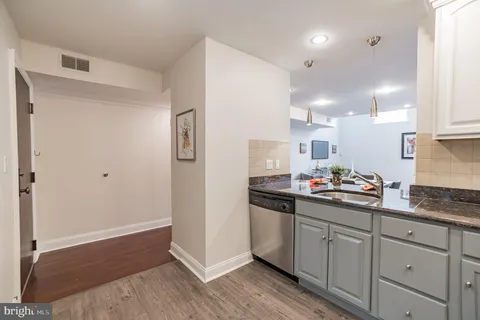 a kitchen with stainless steel appliances granite countertop a refrigerator a stove a sink and a microwave