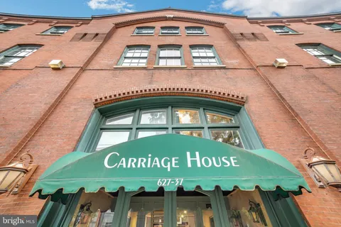 a view of a brick building next to a yard