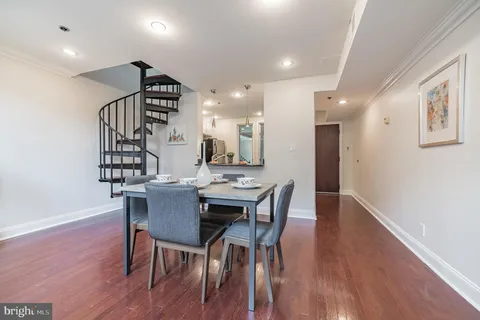 a room with lots of potted plants and white countertops