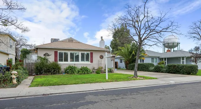 a front view of house with yard and green space