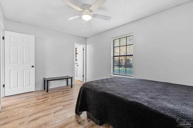 a bathroom with a granite countertop sink toilet and a mirror