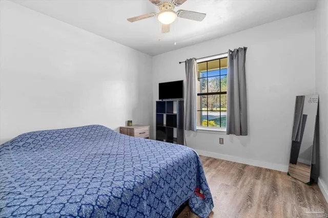 a bedroom with a bed and a chandelier