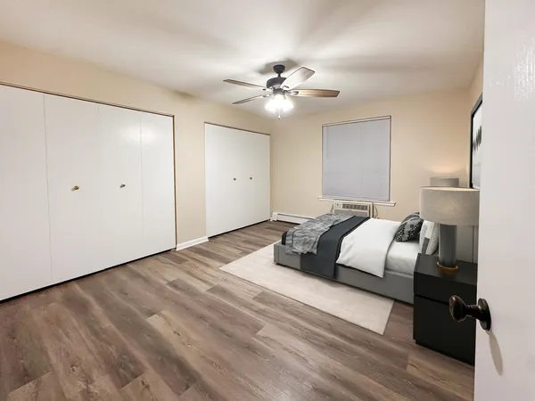 a bedroom with a bed and wooden floor