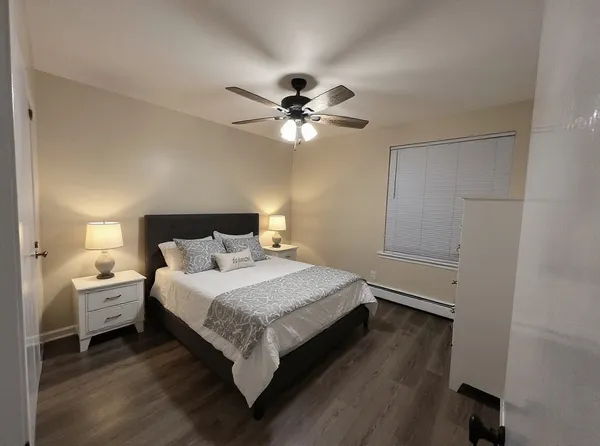 a bedroom with a bed and a ceiling fan