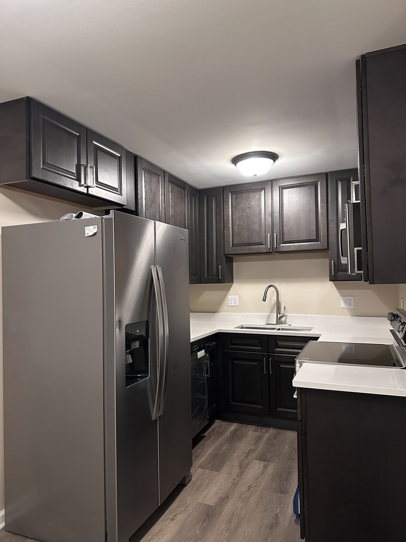 2500 Light Road, Unit 106 Oswego, IL 60543 - Photo 2 of 15 a kitchen with stainless steel appliances granite countertop a sink stove and refrigerator
