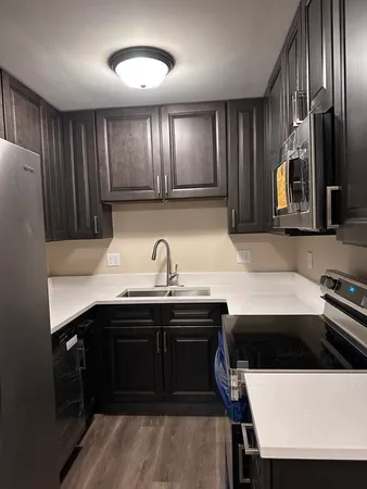 a kitchen with stainless steel appliances a sink and a refrigerator