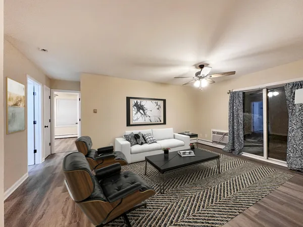 a living room with furniture and a chandelier