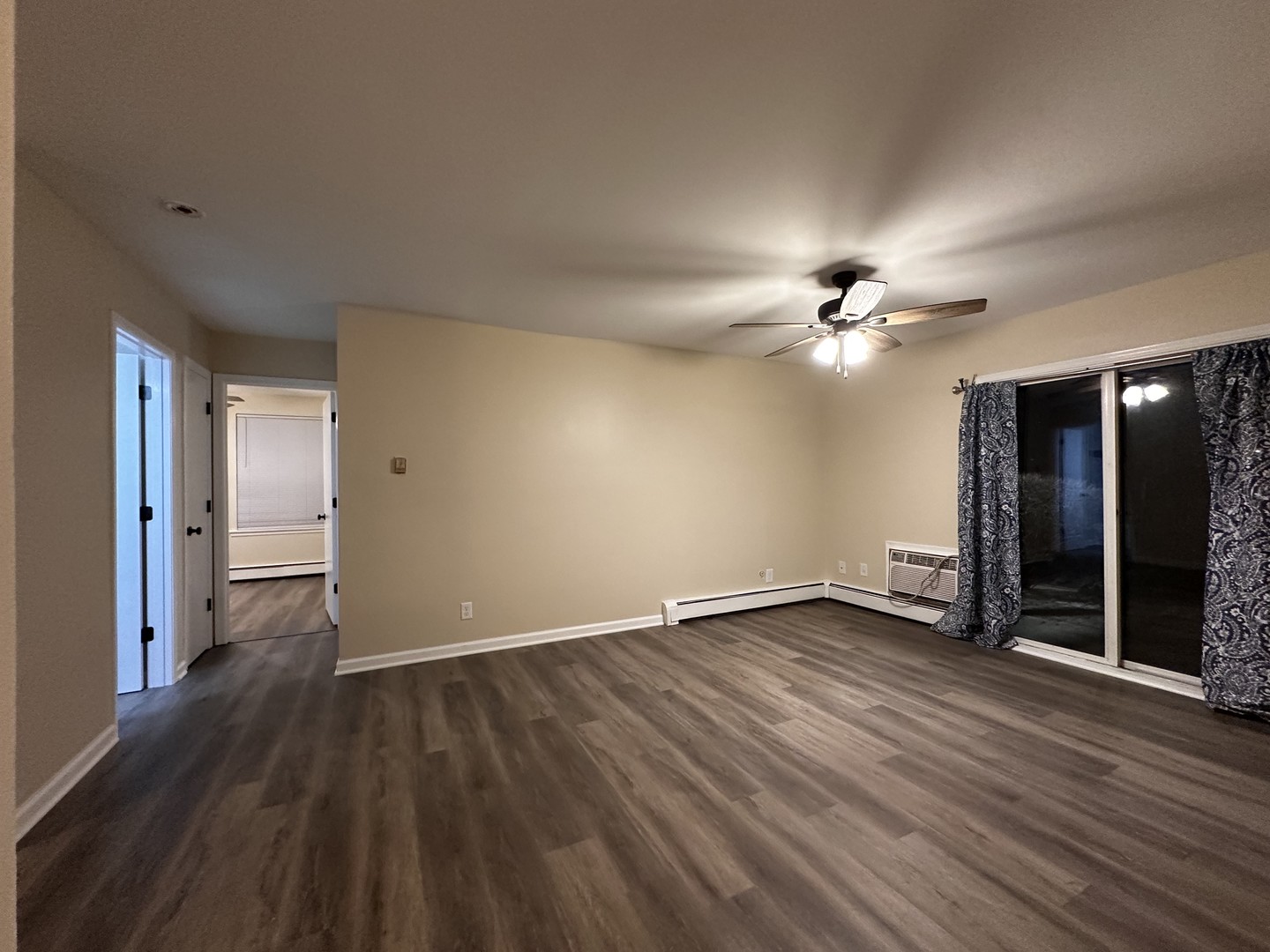 2500 Light Road, Unit 106 Oswego, IL 60543 - Photo 5 of 15 a view of an empty room with wooden floor and a ceiling fan