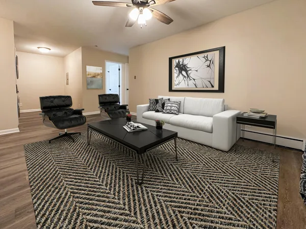 a living room with furniture a rug and a wall painting