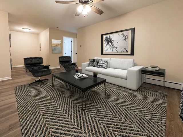 a living room with furniture a rug and a wall painting