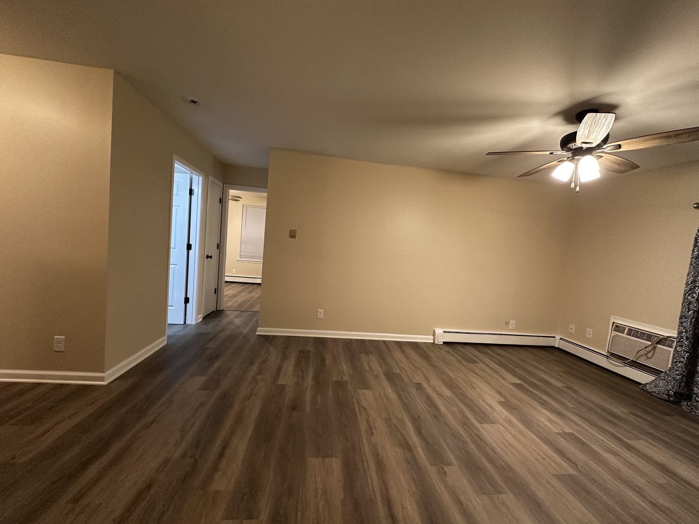 2500 Light Road, Unit 106 Oswego, IL 60543 - Photo 8 of 15 an empty room with wooden floor and windows