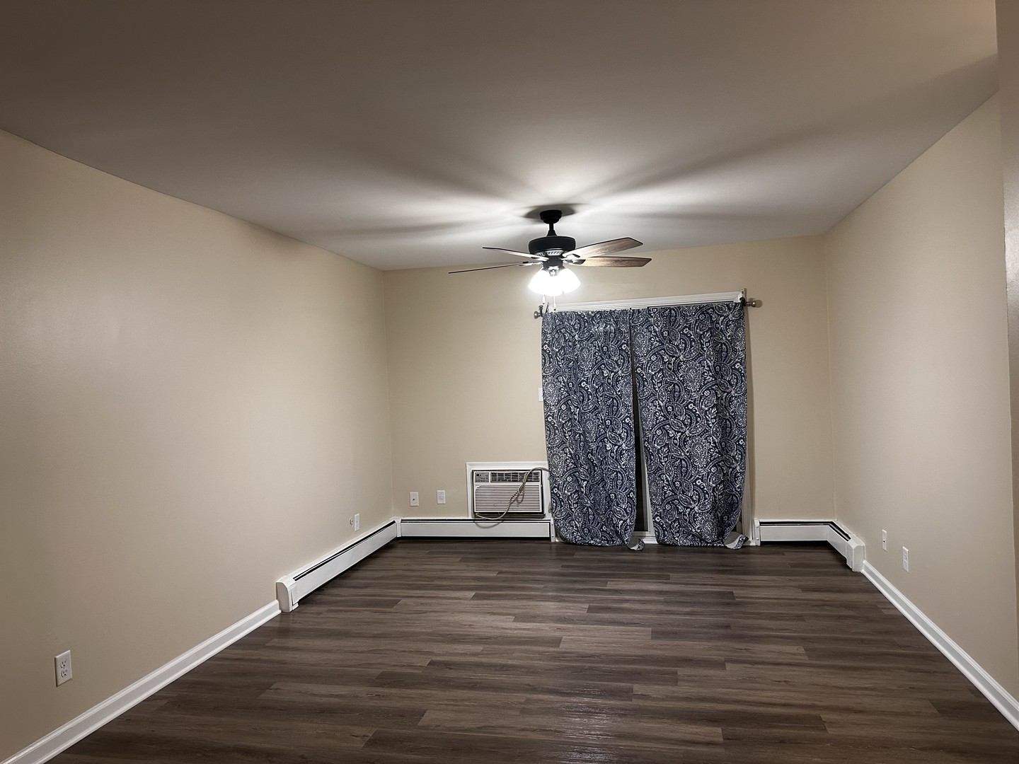 2500 Light Road, Unit 106 Oswego, IL 60543 - Photo 9 of 15 a view of wooden floor in an empty room with a chandelier