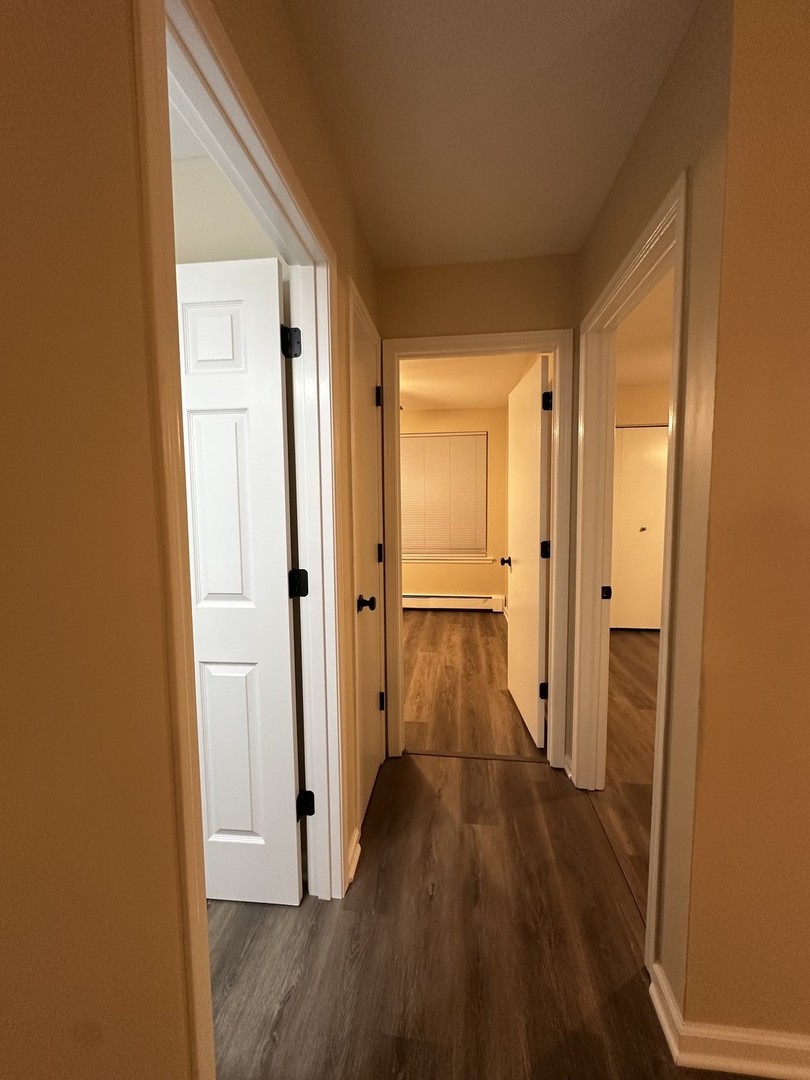 2500 Light Road, Unit 106 Oswego, IL 60543 - Photo 10 of 15 a view of a hallway with wooden floor