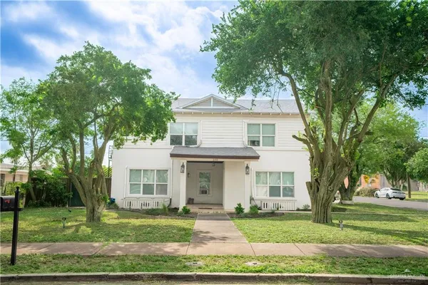 a front view of a house with a garden