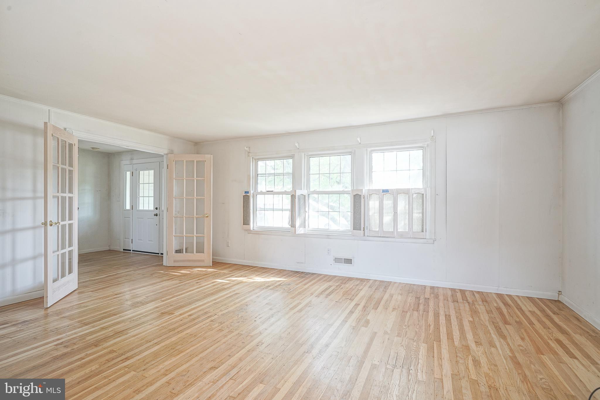 152 Kelly Driver Road Laurel Springs, NJ 08021 - Photo 4 of 30 an empty room with wooden floor and windows