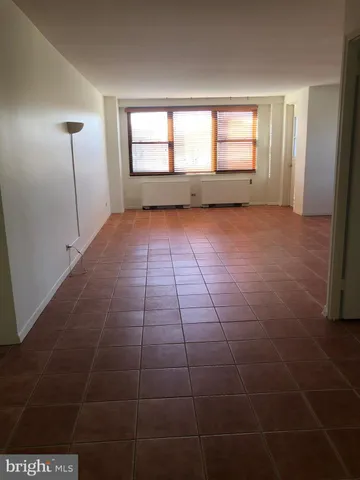 an empty room with windows and entrance