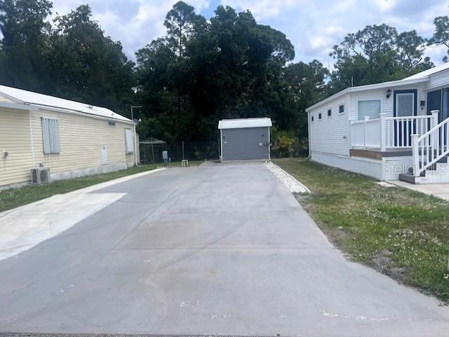 1723 East Manatee Loop Punta Gorda, FL 33950 - Photo 3 of 17 a view of a house with a yard and garage