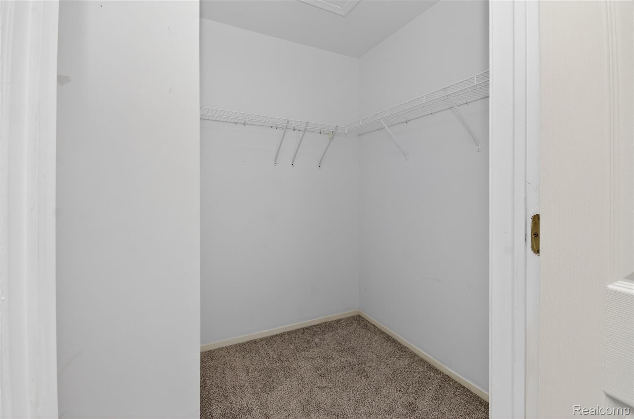 70 Pine Tree Ridge, Unit 2 Waterford, MI 48327 - Photo 18 of 36 Walk in closet with light colored carpet