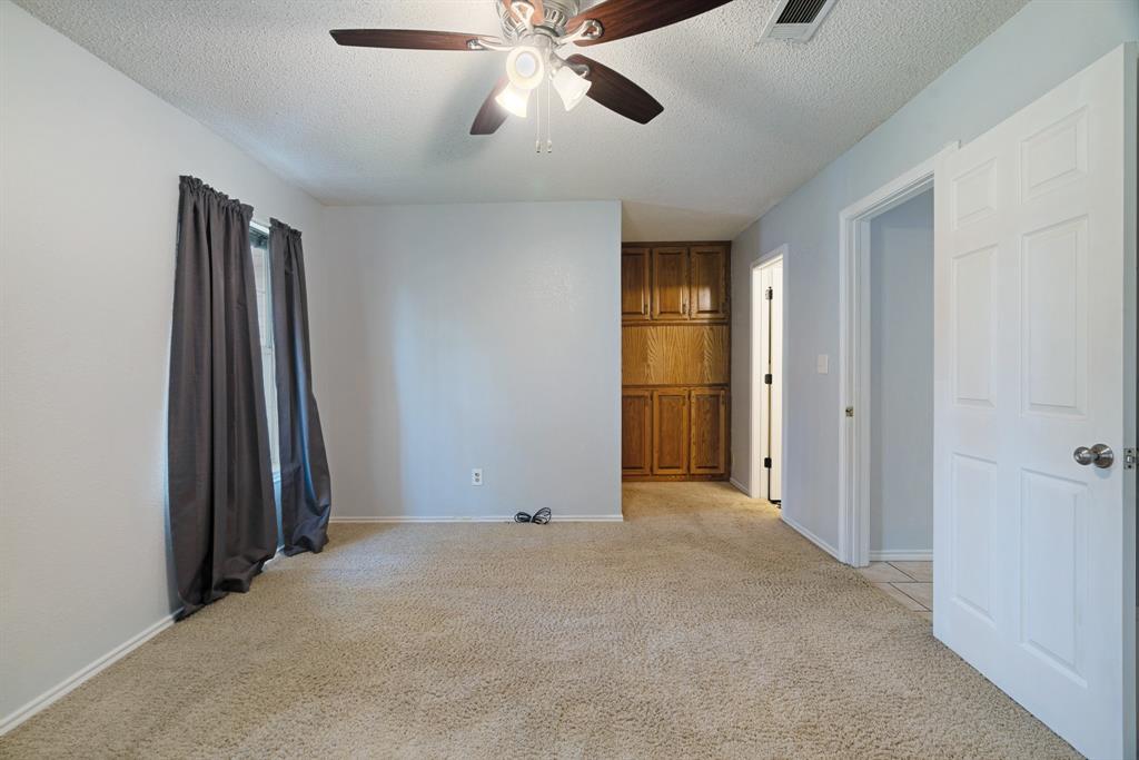 201 County Road Powderly, TX 75473 - Photo 11 of 26 an empty room with closet and a chandelier fan