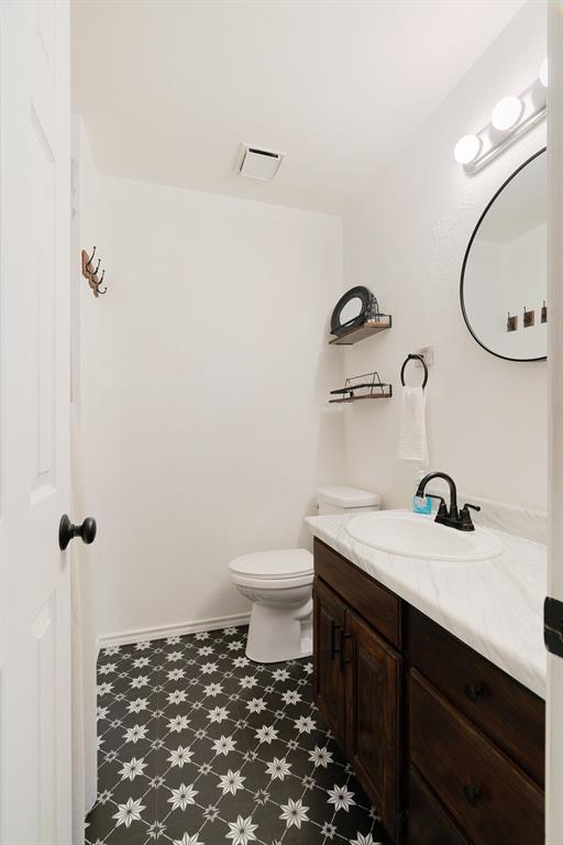 201 County Road Powderly, TX 75473 - Photo 12 of 26 a bathroom with a sink a toilet and a mirror