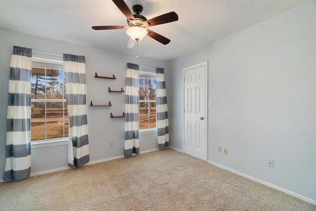 201 County Road Powderly, TX 75473 - Photo 13 of 26 a view of empty room with windows and ceiling fan