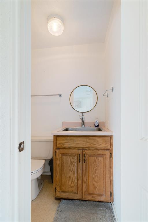 201 County Road Powderly, TX 75473 - Photo 18 of 26 a bathroom with a toilet a sink and a mirror