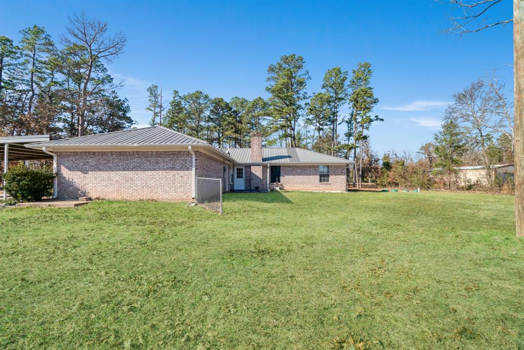 201 County Road Powderly, TX 75473 - Photo 24 of 26 a view of a house with backyard and garden