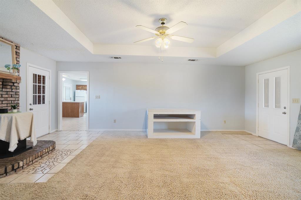 201 County Road Powderly, TX 75473 - Photo 3 of 26 an empty room with windows and ceiling fan
