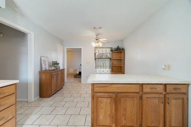 a kitchen with stainless steel appliances granite countertop a sink counter space and a refrigerator