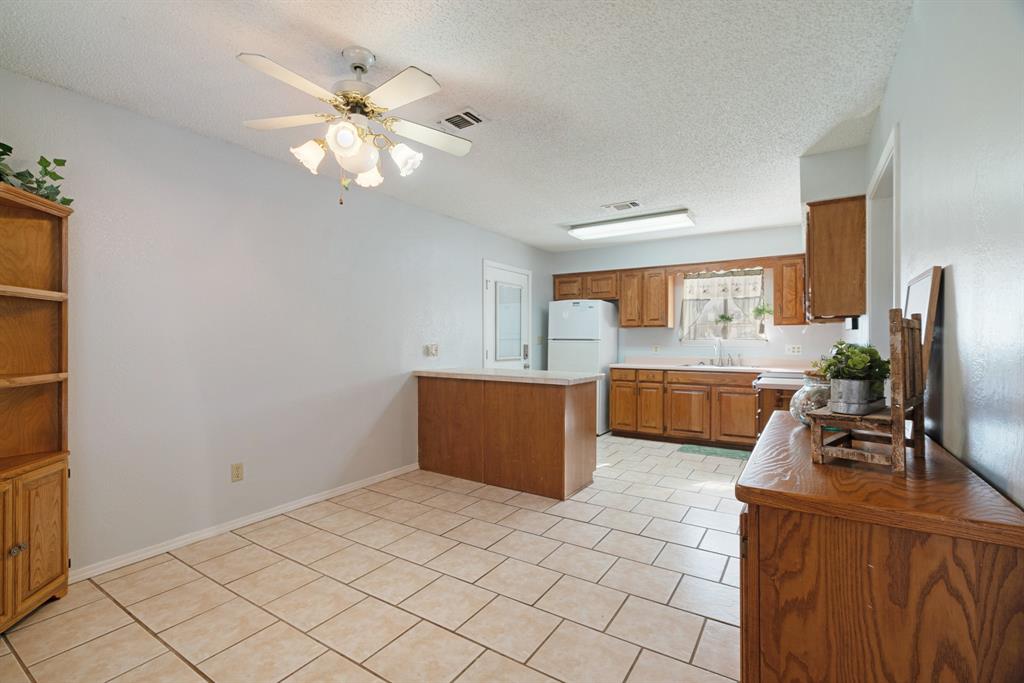 201 County Road Powderly, TX 75473 - Photo 8 of 26 a kitchen with a cabinets and chandelier