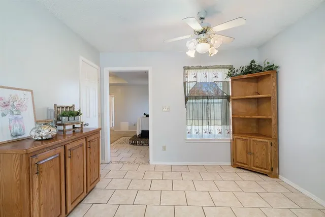 an empty room with closet and a ceiling fan