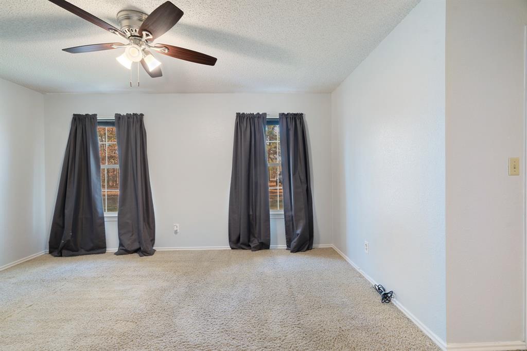 201 County Road Powderly, TX 75473 - Photo 10 of 26 an empty room with closet and a ceiling fan
