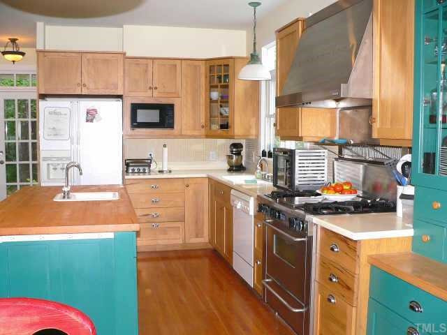 6723 Stagville Road Bahama, NC 27503 - Photo 6 of 10 Kit-custom pecan cabinets, Corian counters, tile backsplash, butcher block center island w/vegetable sink, restaurant style 4-burner gas range w/griddle. Beautiful dining area & custom pecan blt-in bookcases w/cabinets below on opposite wall Other