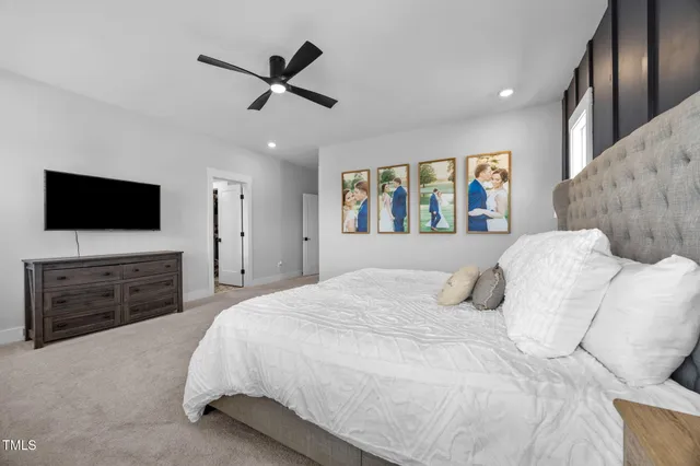 a bedroom with a bed and a painting on the wall