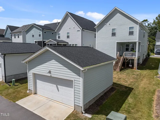 a aerial view of a house with yard