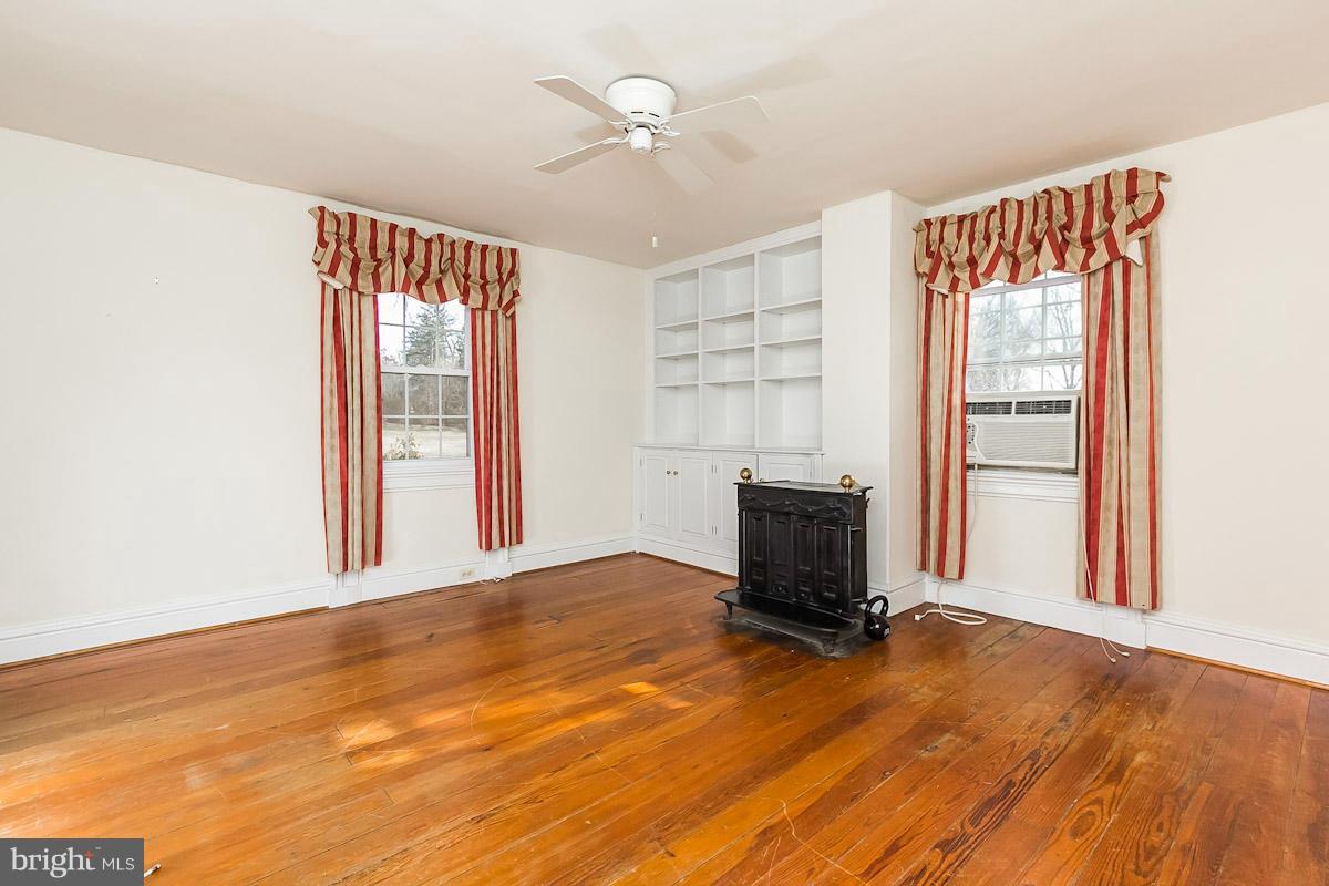 2105 Western Run Road Cockeysville, MD 21030 - Photo 3 of 12 wooden floor in an empty room with a window
