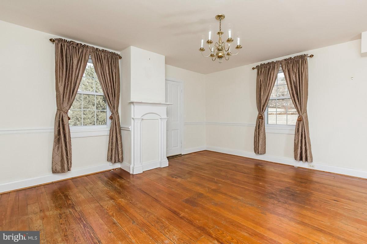 2105 Western Run Road Cockeysville, MD 21030 - Photo 4 of 12 a view of empty room with wooden floor and fan