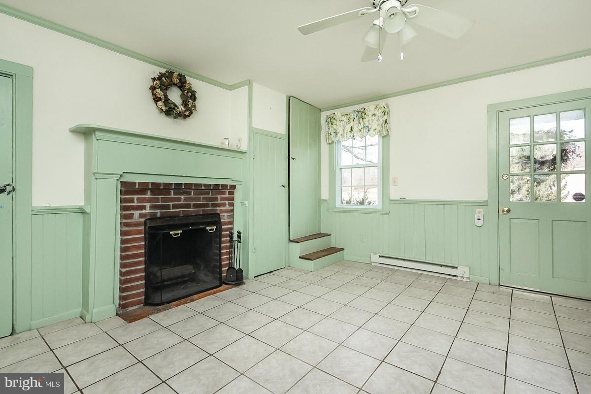 2105 Western Run Road Cockeysville, MD 21030 - Photo 6 of 12 a view of an empty room with a fireplace and a window