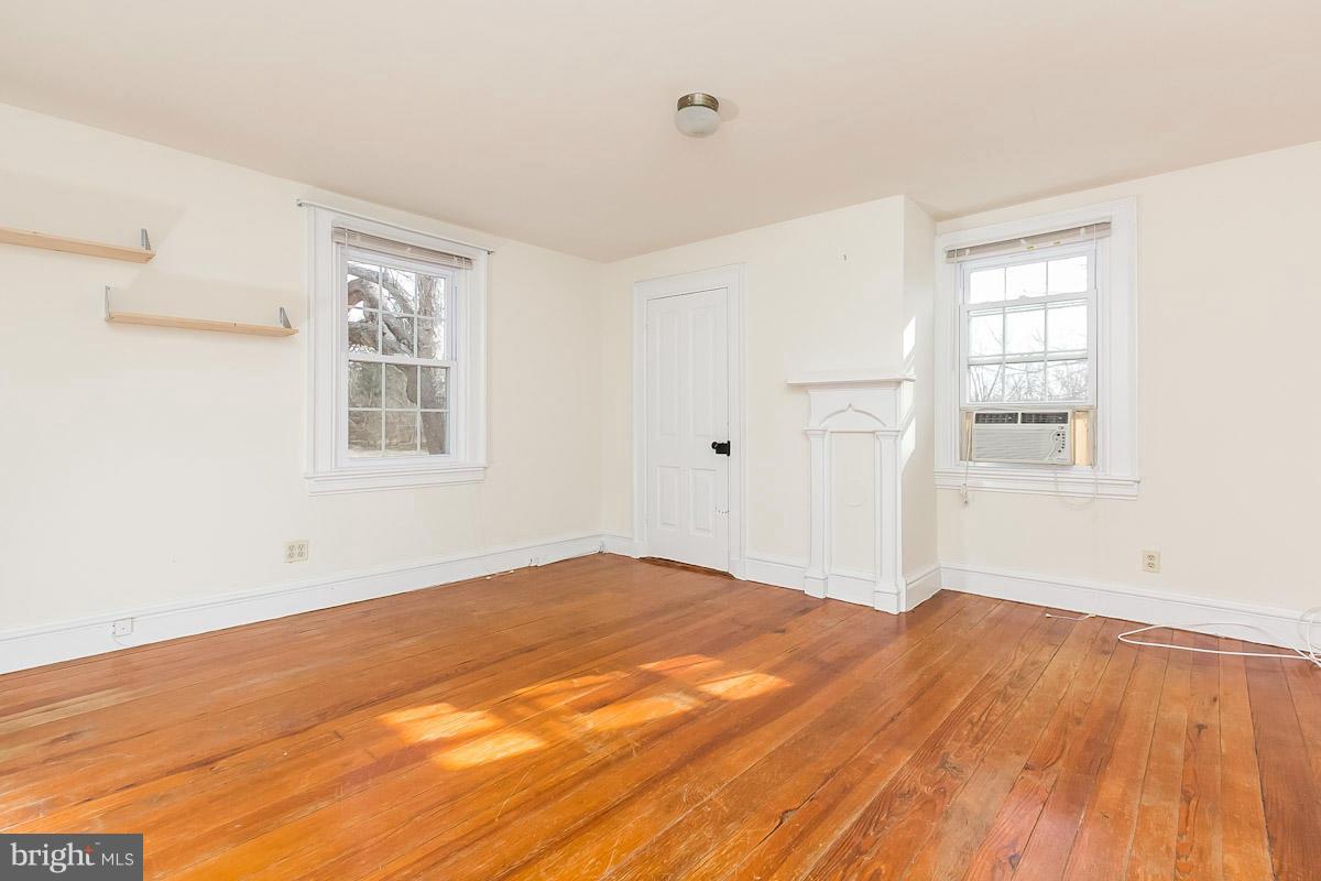 2105 Western Run Road Cockeysville, MD 21030 - Photo 8 of 12 an empty room with wooden floor and windows