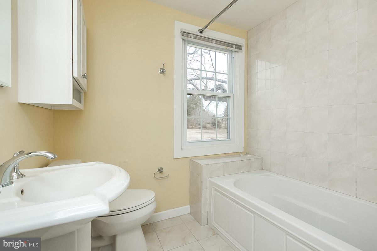 2105 Western Run Road Cockeysville, MD 21030 - Photo 10 of 12 a bathroom with a sink a toilet and bathtub