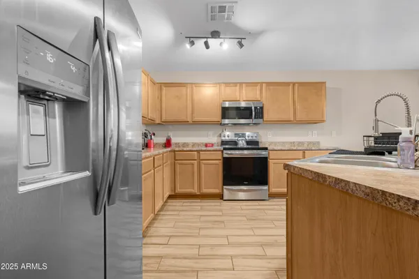 a kitchen with a sink cabinets and wooden floor