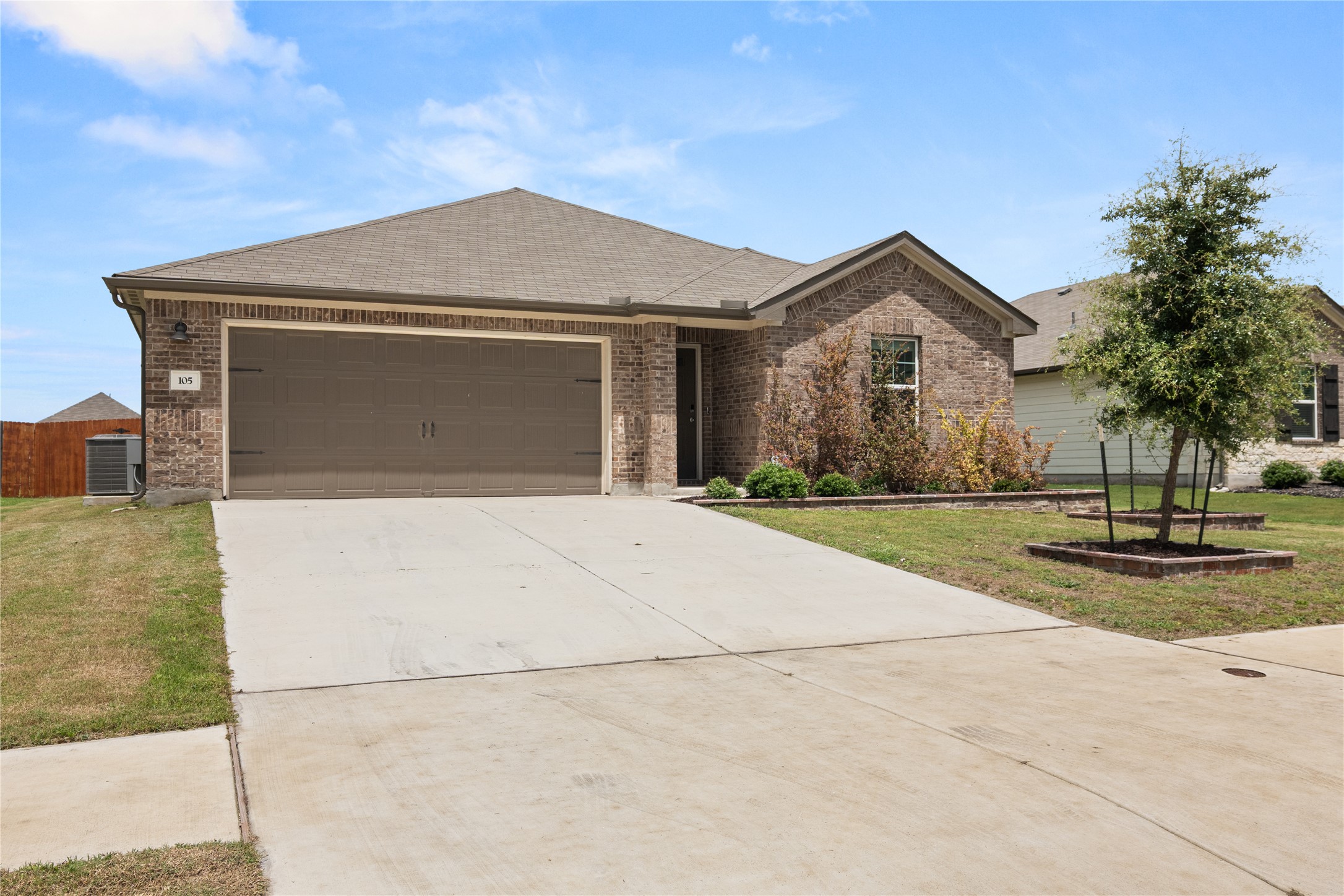 105 Saviano Road Hutto, TX 78634 - Photo 20 of 22 A classic brick exterior and attached garage provide a charming, inviting facade.