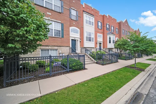 a view of a brick building next to a yard