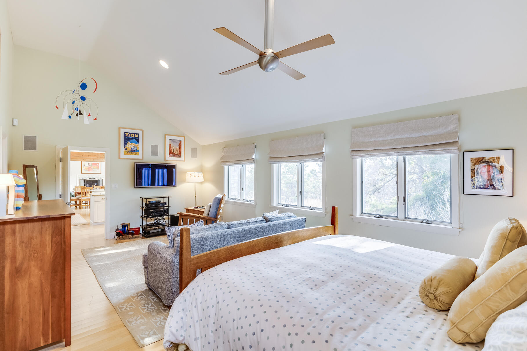 65 Massasoit Road Wellfleet, MA 02667 - Photo 43 of 86 a spacious bedroom with a bed a window and a chandelier
