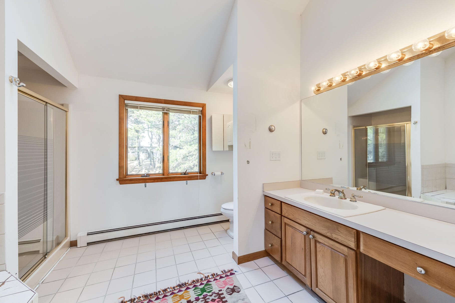 65 Massasoit Road Wellfleet, MA 02667 - Photo 44 of 86 a bathroom with a double vanity sink a mirror and a bathtub