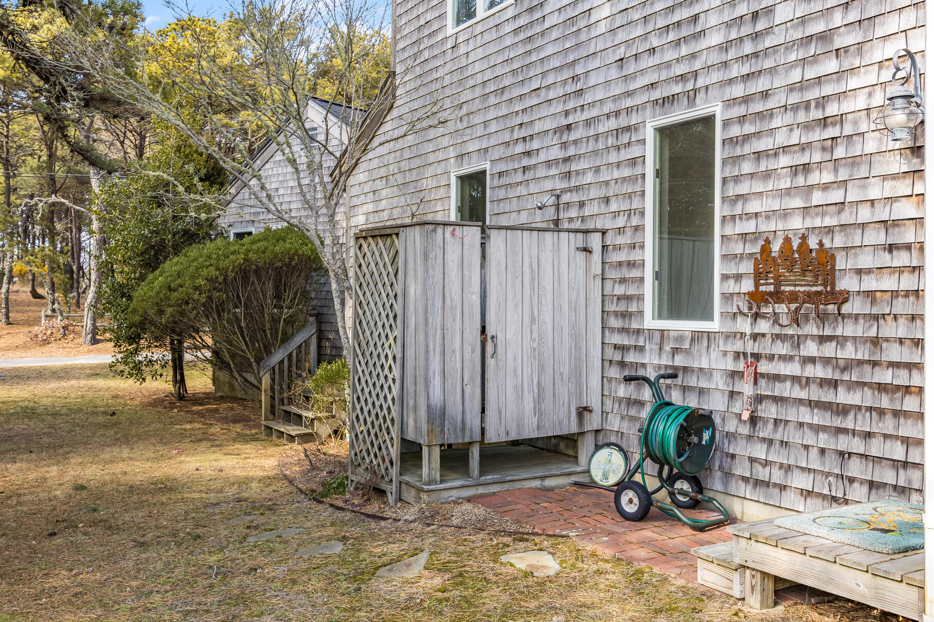 65 Massasoit Road Wellfleet, MA 02667 - Photo 78 of 86 a view of backyard with a chair and table in the patio