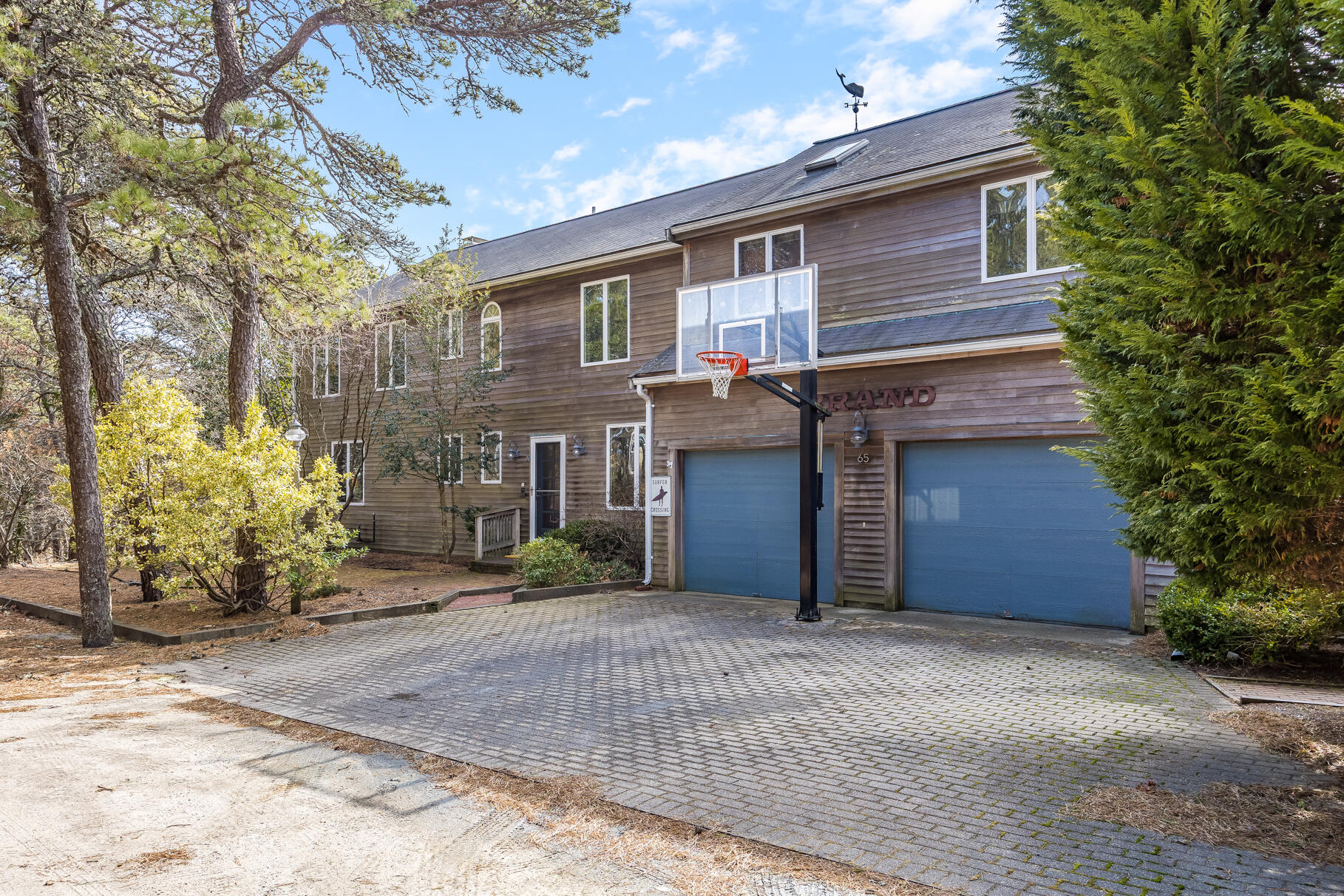 65 Massasoit Road Wellfleet, MA 02667 - Photo 8 of 86 a view of a house with a yard and garage