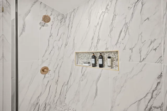 a spacious bathroom with a double vanity sink a mirror and a