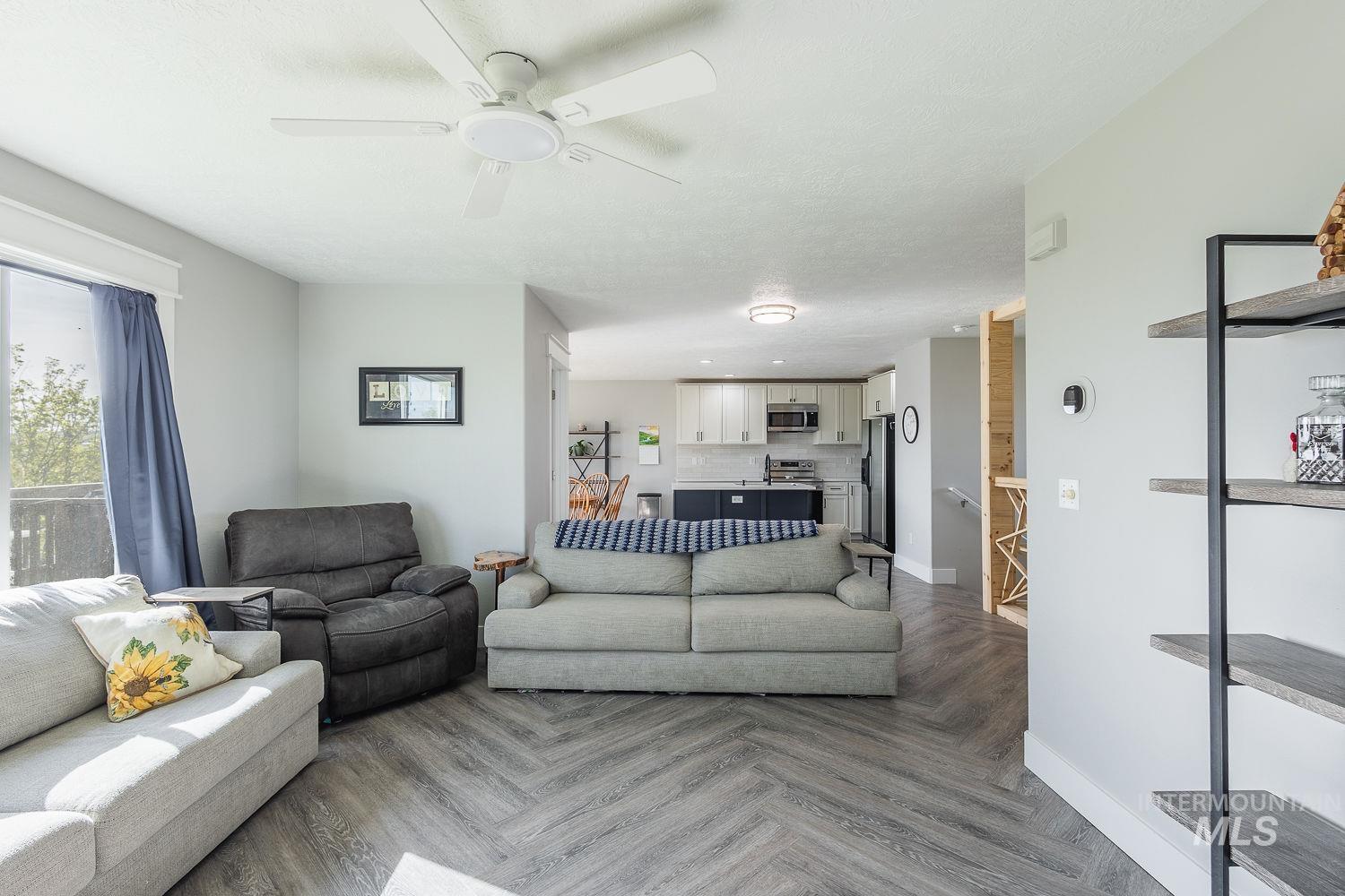 3950 Cassia Road New Plymouth, ID 83655 - Photo 14 of 26 Living room featuring parquet floors, ceiling fan, and recessed lighting